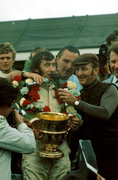 les leston interviewing jackie stewart at the British grand prix after he won the race 1969